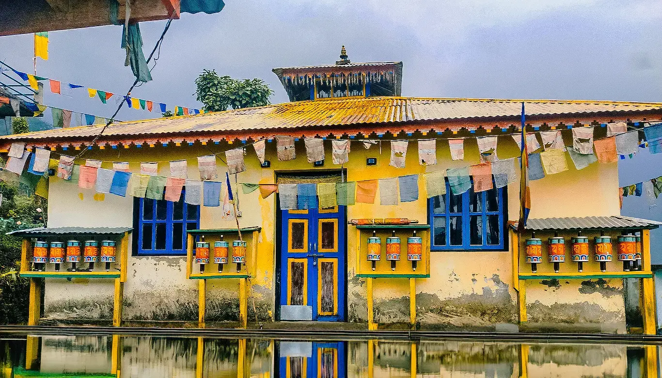 Monastery in Labdang, West Sikkim, Gurung Heritage Village with colorful prayer flags and traditional prayer wheels.